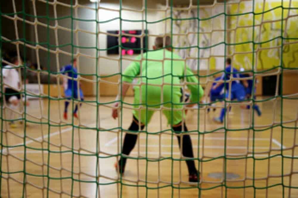 Futsal goalie in ready stance.
